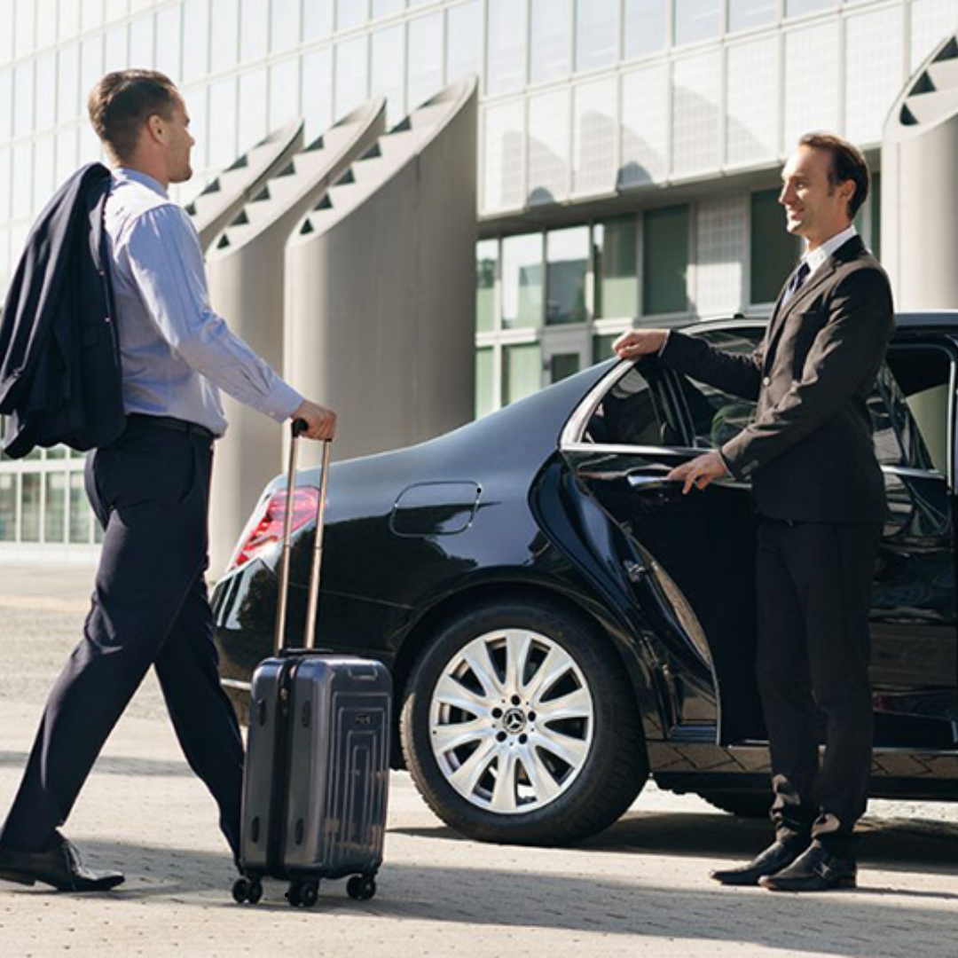 Chauffeur TransfertShuttel ouvrant la portière d'une berline premium à Paris